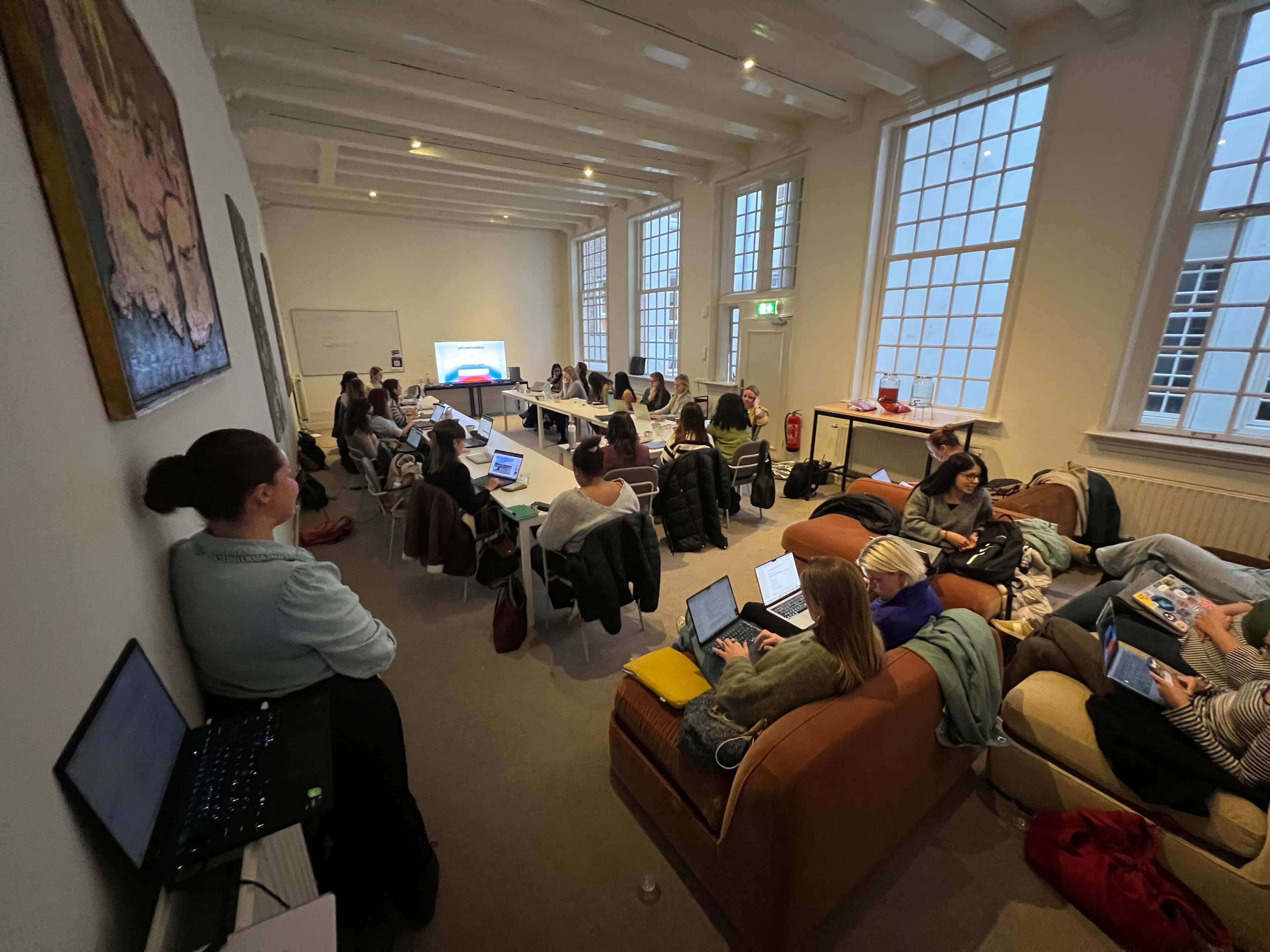 Women coding side by side at a Ladies Build With AI hackathon