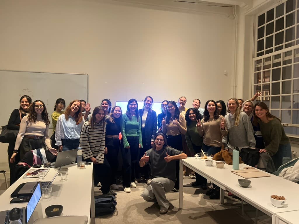 Group photo of women smiling and posing together after a Ladies Build With AI vibe coding hackathon